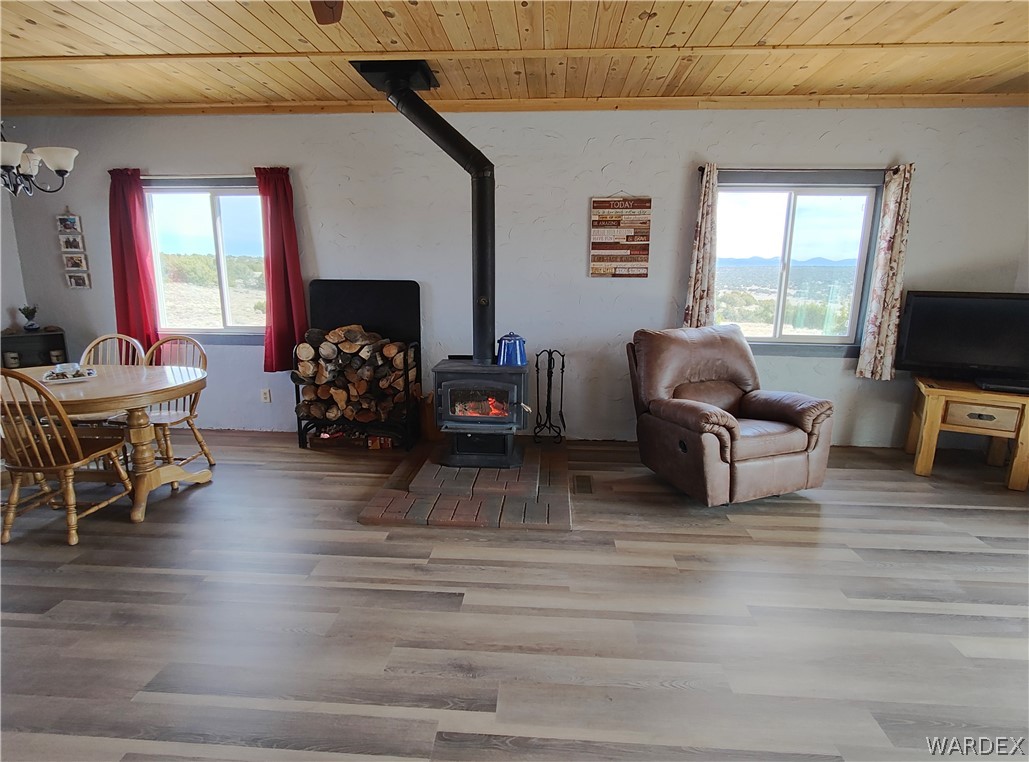 15 County Road Concho, AZ 85924 - Photo 26 of 93 Wood-finish flooring throughout, featuring a central wood-burning stove with a brick hearth