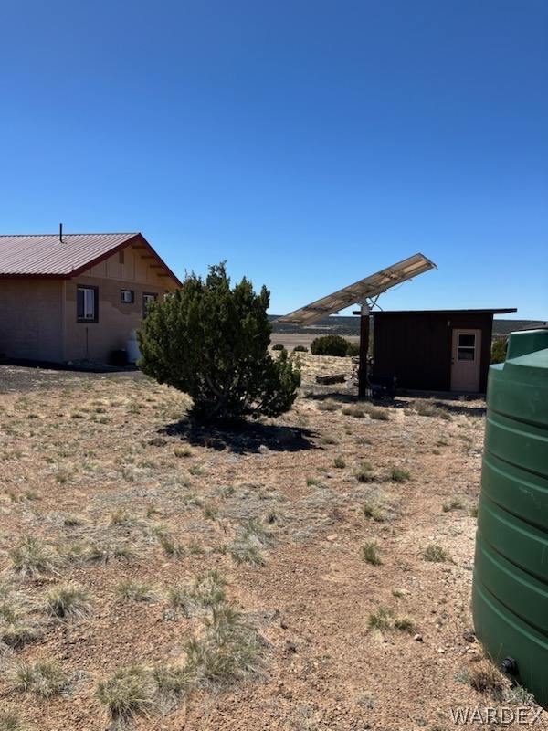 15 County Road Concho, AZ 85924 - Photo 36 of 93 Off-grid property featuring a metal roof structure, a separate utility building, and a solar panel array