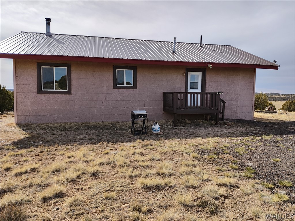 15 County Road Concho, AZ 85924 - Photo 63 of 93 Exterior featuring a metal roof, stucco-like siding, and multiple windows with dark trim