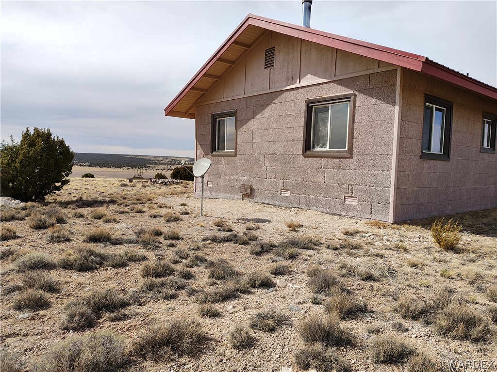 15 County Road Concho, AZ 85924 - Photo 65 of 93 Adobe-style exterior featuring a red gable roof and stucco siding