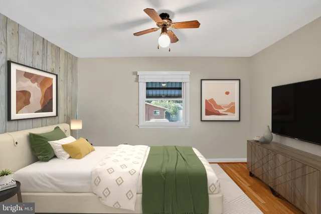 a bedroom with a bed and a painting on the wall