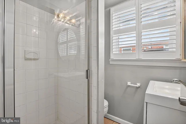 a spacious bedroom with a bed and a chandelier