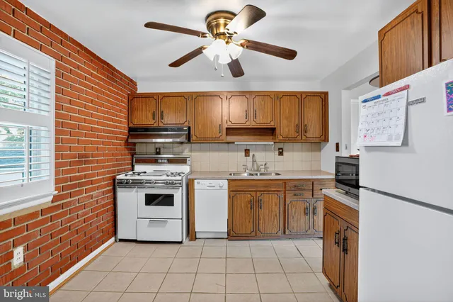 a kitchen with stainless steel appliances granite countertop a stove sink and cabinets