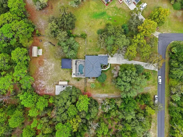 an aerial view of a house with garden space and street view