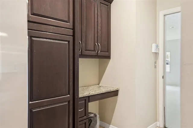 a view of a porch with chairs and a small yard