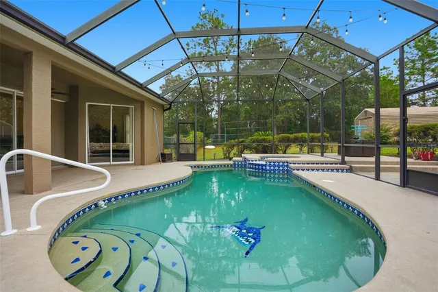 an aerial view of residential houses with outdoor space and trees