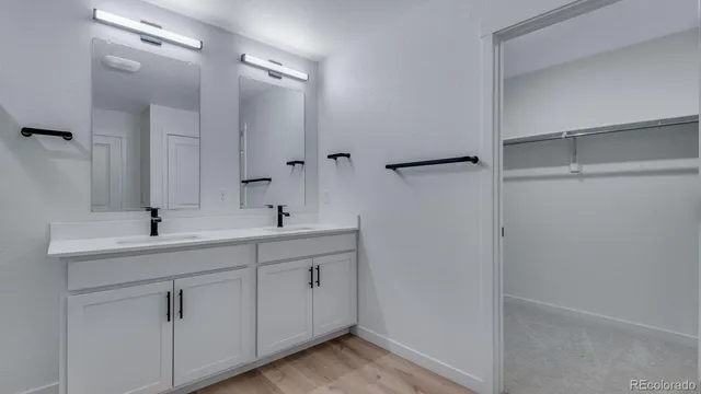 a bathroom with a double vanity sink and mirror