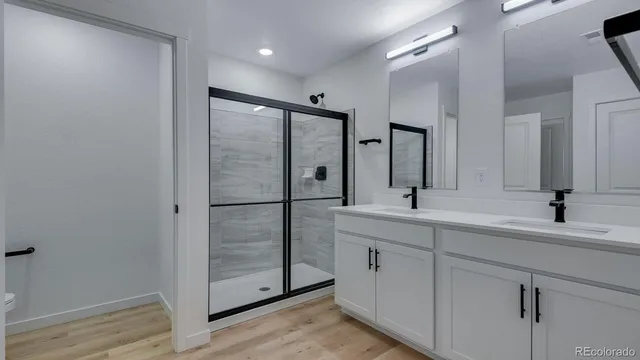 a bathroom with a double vanity sink and mirror