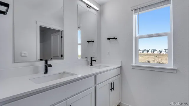 a bathroom with double sink and a mirror