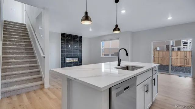 a kitchen with a sink and a refrigerator