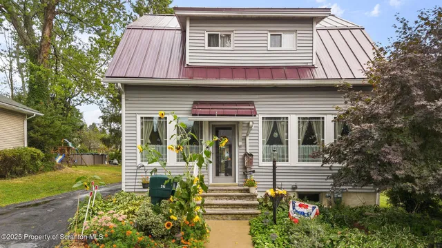 a front view of a house with garden