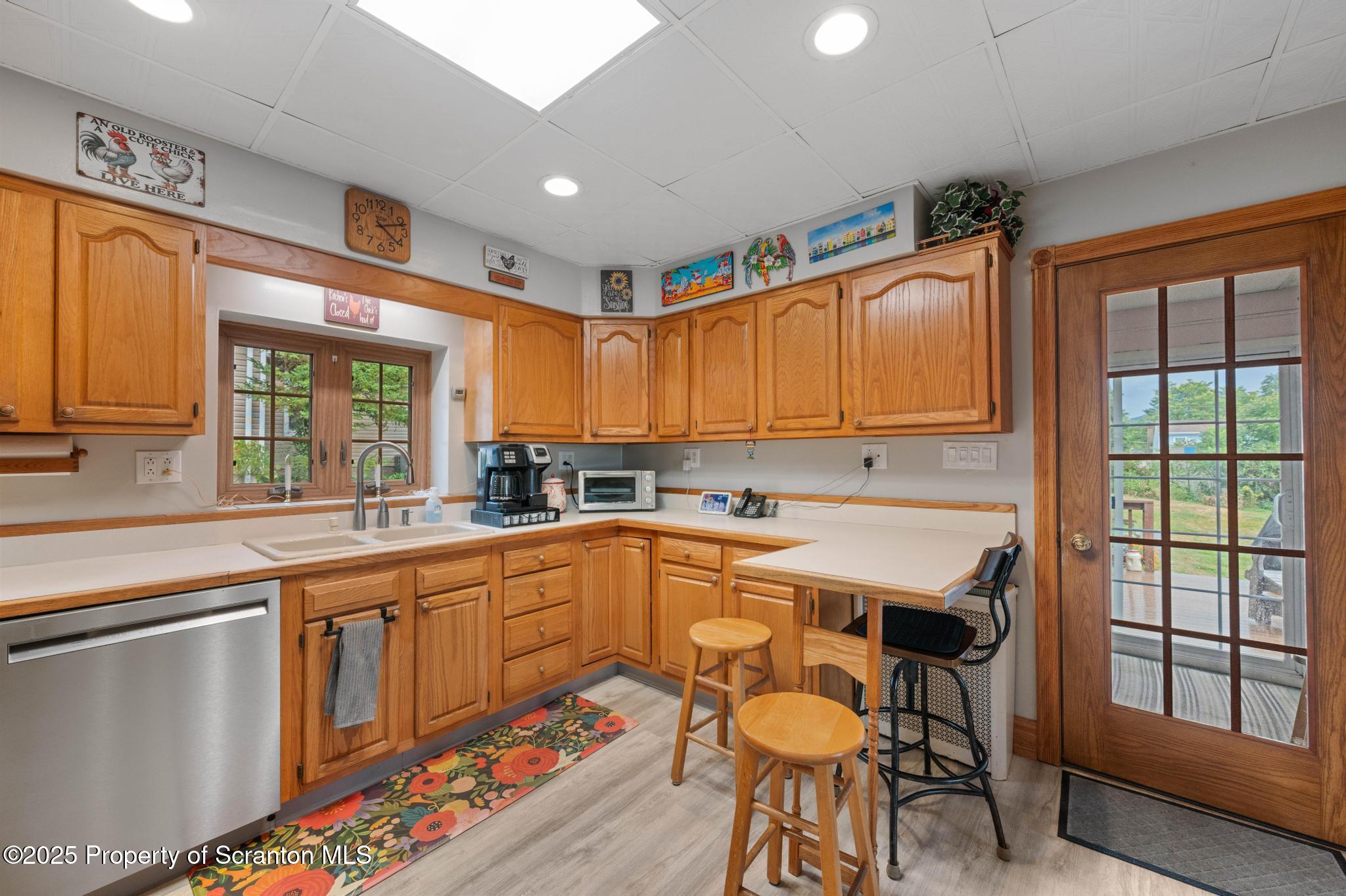 216 Maple Avenue Clarks Summit, PA 18411 - Photo 18 of 51 a kitchen with stainless steel appliances granite countertop a stove a sink and a refrigerator