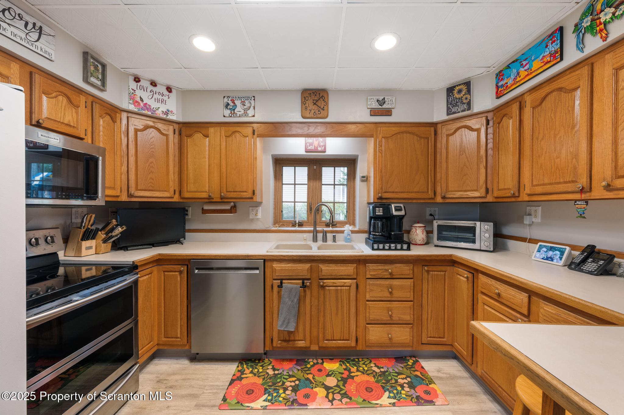 216 Maple Avenue Clarks Summit, PA 18411 - Photo 19 of 51 a kitchen with stainless steel appliances granite countertop a sink stove and cabinets