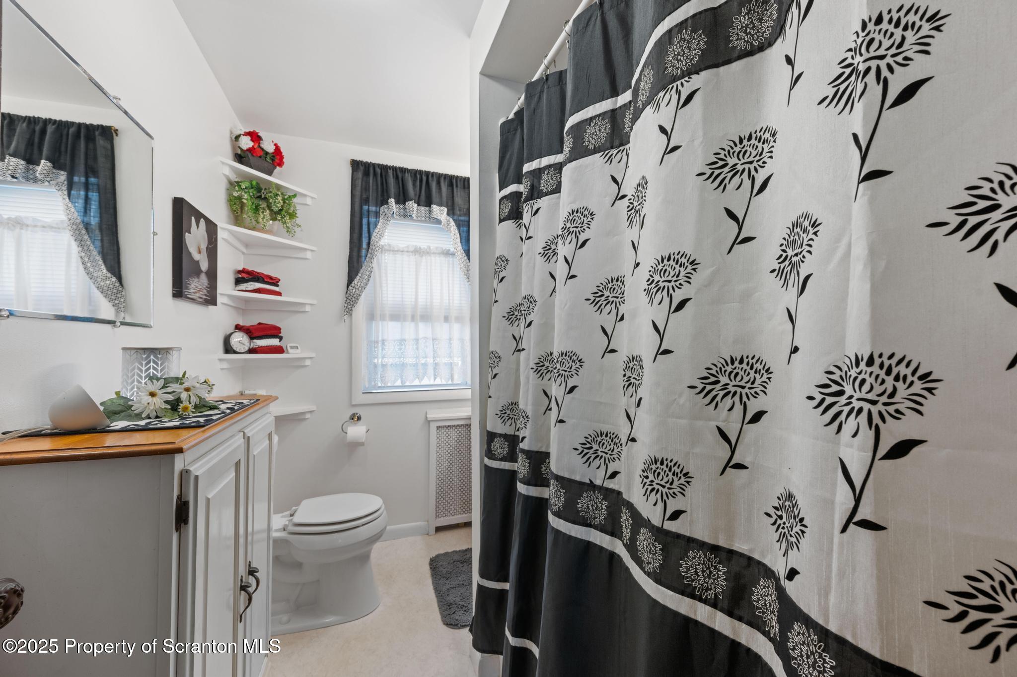 216 Maple Avenue Clarks Summit, PA 18411 - Photo 30 of 51 a white toilet sitting next to a bathroom sink