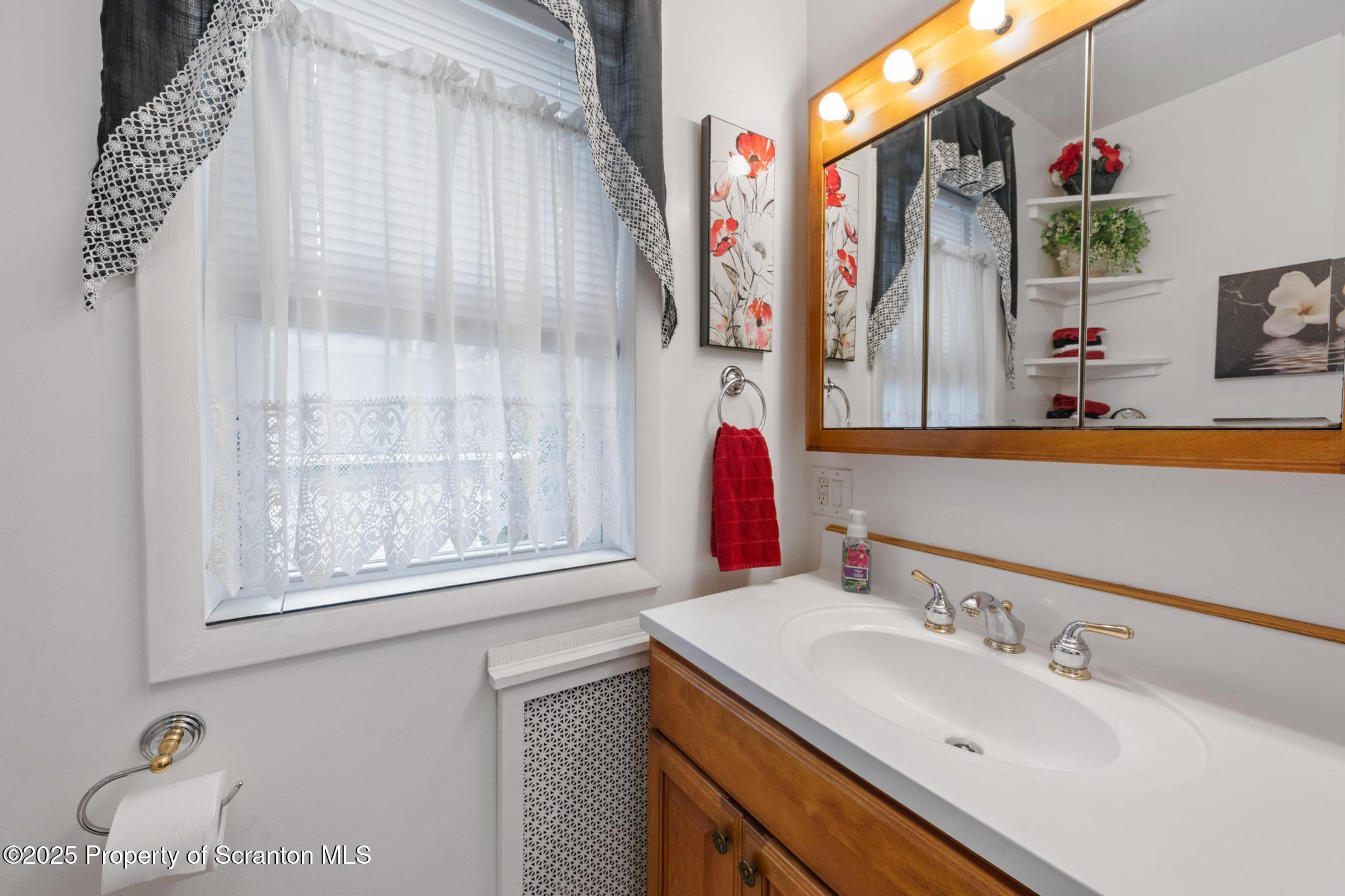 216 Maple Avenue Clarks Summit, PA 18411 - Photo 31 of 51 a bathroom with a sink and a mirror