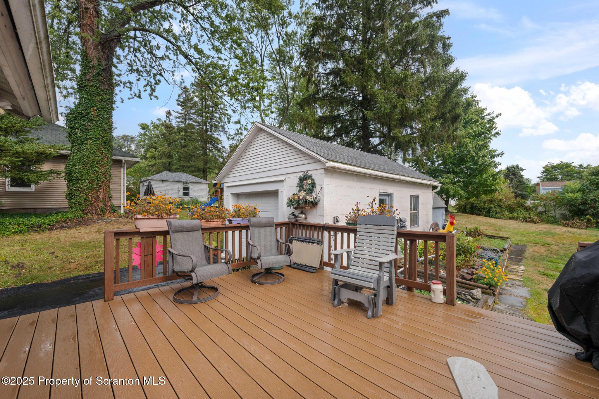 216 Maple Avenue Clarks Summit, PA 18411 - Photo 37 of 51 a view of house with deck outdoor seating and trees in the background