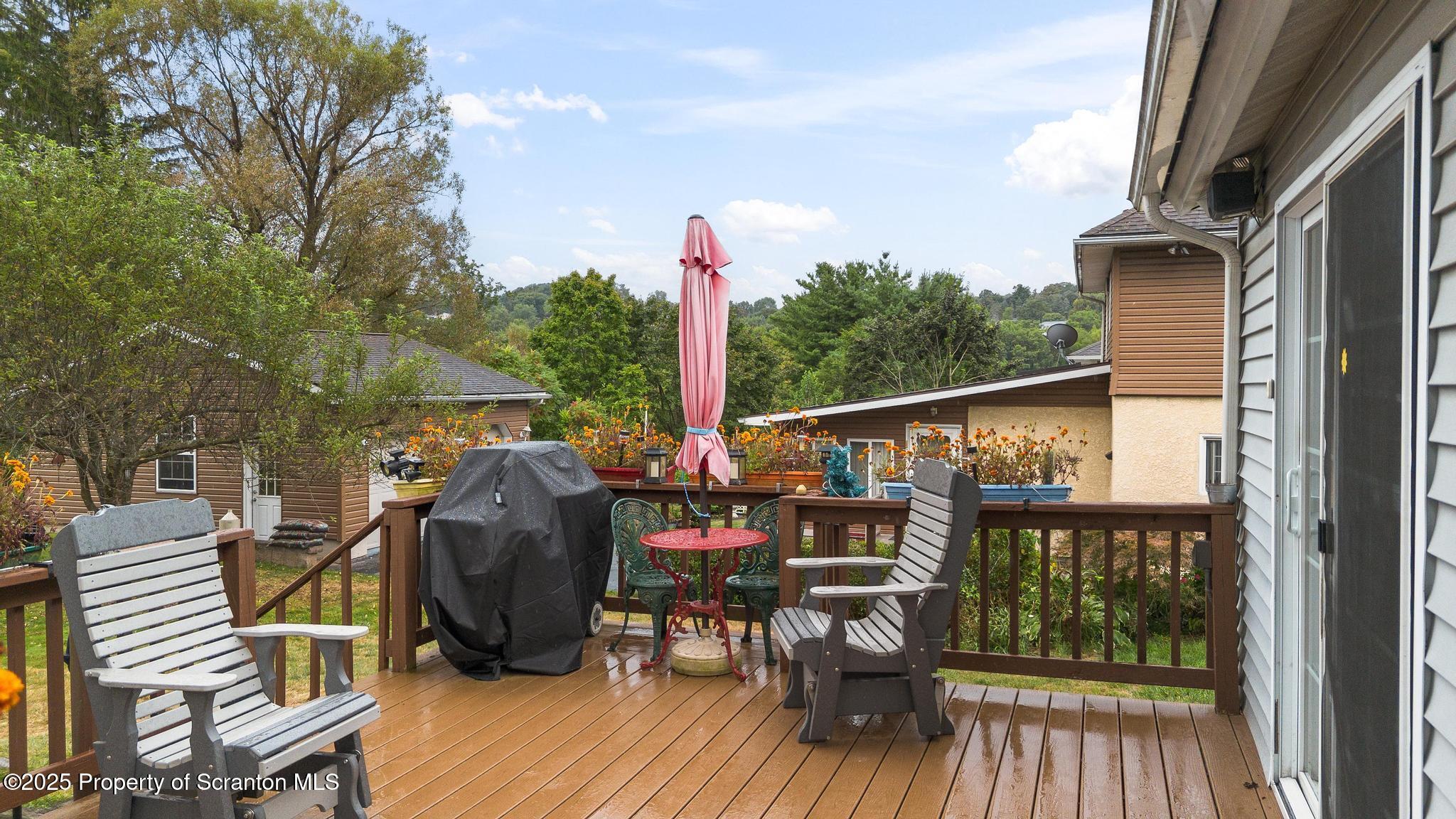 216 Maple Avenue Clarks Summit, PA 18411 - Photo 38 of 51 a view of deck with table and chairs and wooden floor