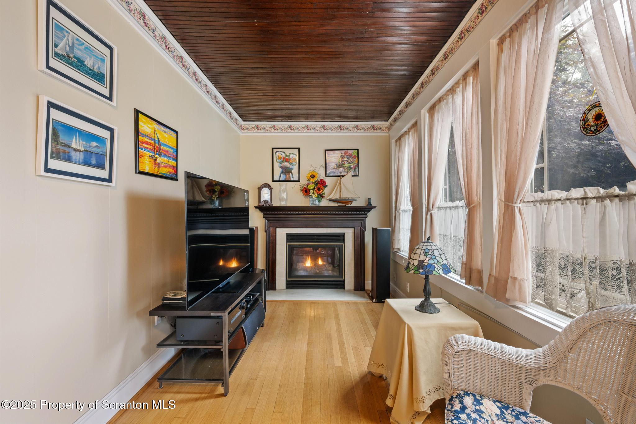 216 Maple Avenue Clarks Summit, PA 18411 - Photo 5 of 51 a living room with furniture a fireplace and a large window