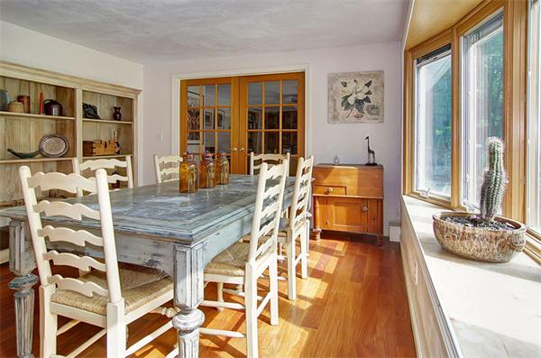 85 Box Mill Road Boxborough, MA 01719 - Photo 14 of 28 a dining hall with stainless steel appliances granite countertop a stove and a dining table with wooden floor
