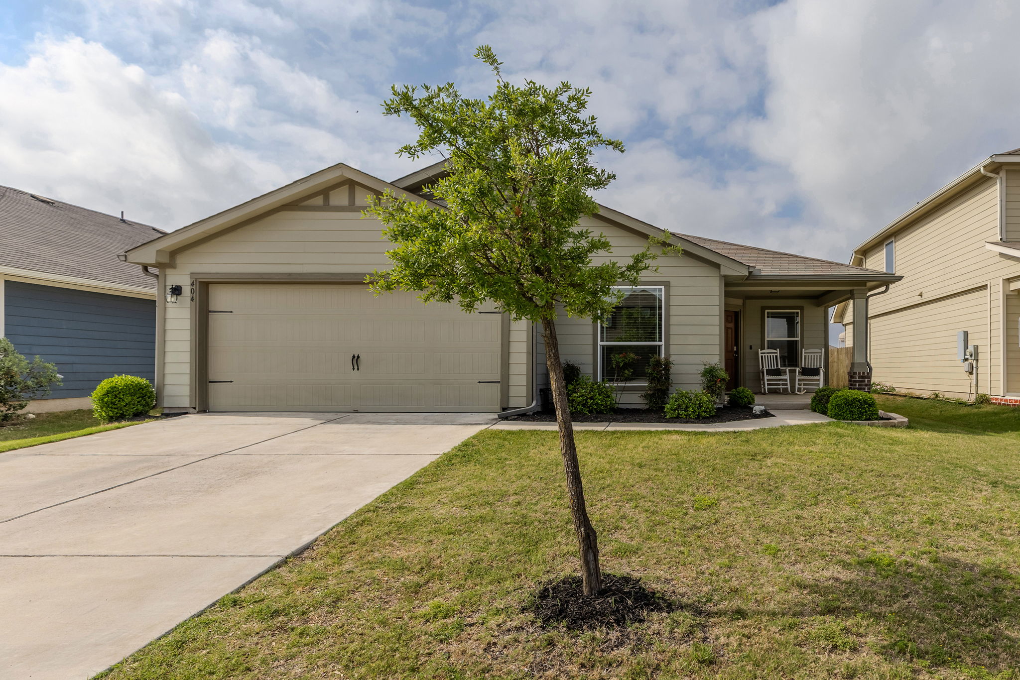 404 Cassandra Drive Hutto, TX 78634 - Photo 1 of 40 Ranch-style home featuring a garage, driveway, and a front yard
