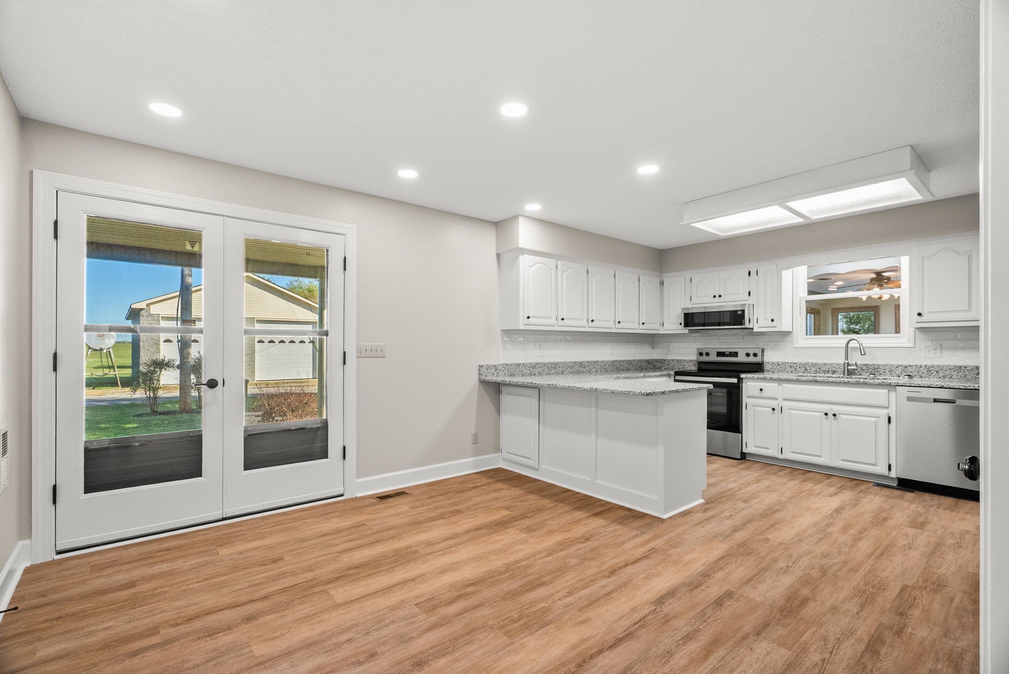 4540 Roy Cole Road Springfield, TN 37172 - Photo 19 of 61 a kitchen with a refrigerator and white cabinets