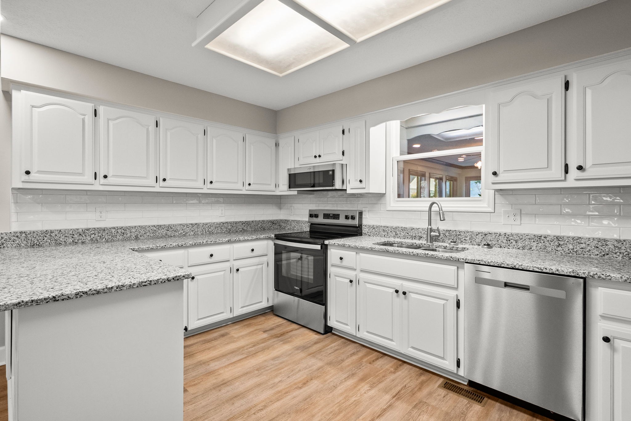 4540 Roy Cole Road Springfield, TN 37172 - Photo 23 of 61 a kitchen with granite countertop white cabinets and white stainless steel appliances