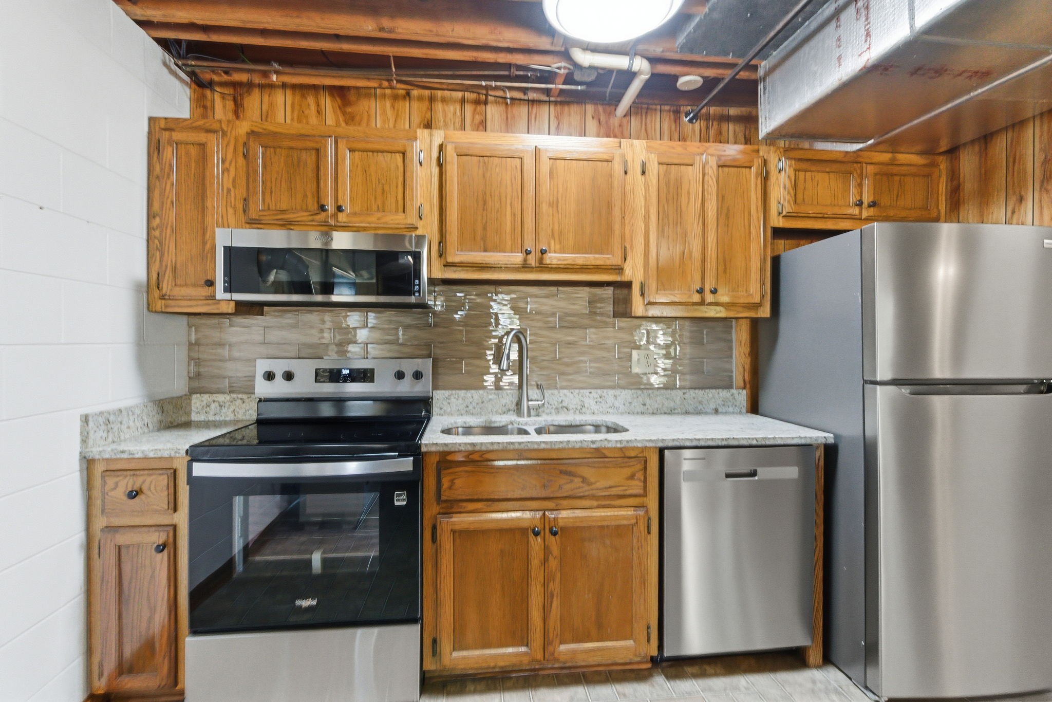 4540 Roy Cole Road Springfield, TN 37172 - Photo 43 of 61 a kitchen with stainless steel appliances granite countertop a stove a refrigerator and a microwave