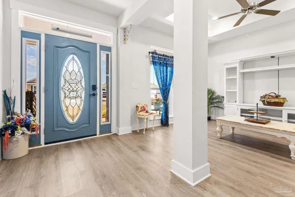a view of an entryway with wooden floor