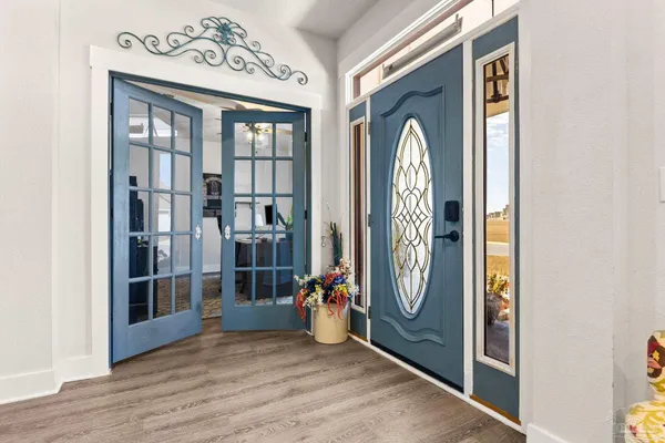 a living room with furniture and a wooden floor