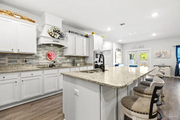 a kitchen with stainless steel appliances granite countertop a sink and cabinets