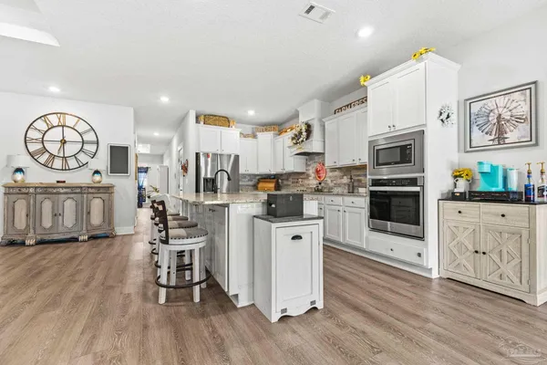 a kitchen with sink stove and cabinets