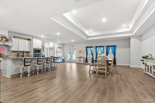 a view of a dining room with furniture window and wooden floor