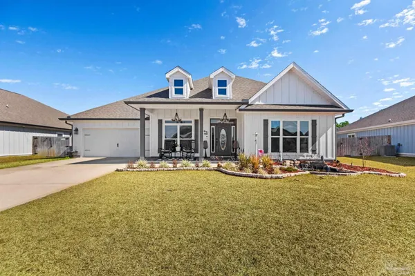 a view of a house with swimming pool and a yard