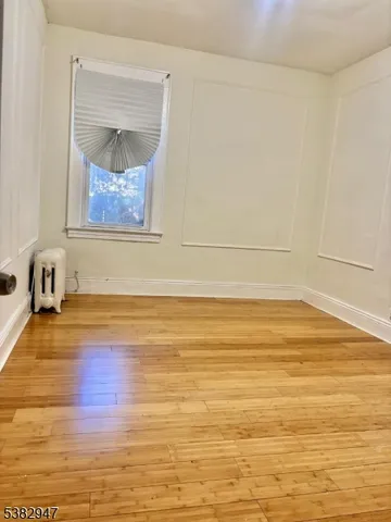 a view of a room with wooden floor and cabinet