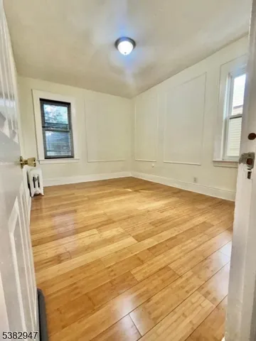a view of a room with a wooden floor and a window