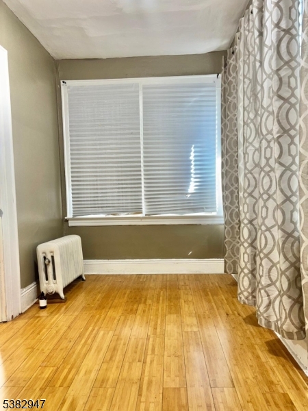 187 Shephard Avenue Newark, NJ 07112 - Photo 13 of 18 a view of a room with a wooden floor and a window