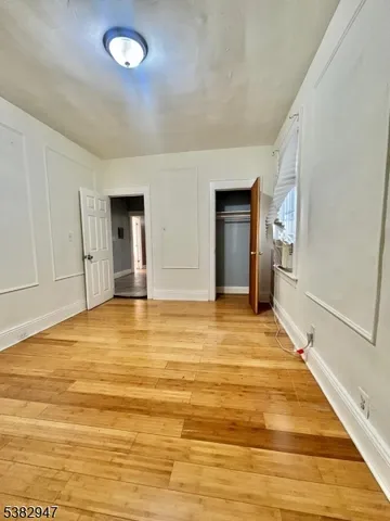 a view of a room with wooden floor and pool table