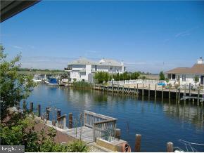 36 Compass Road Waretown, NJ 08758 - Photo 10 of 10 a view of a lake with boats and trees in the background