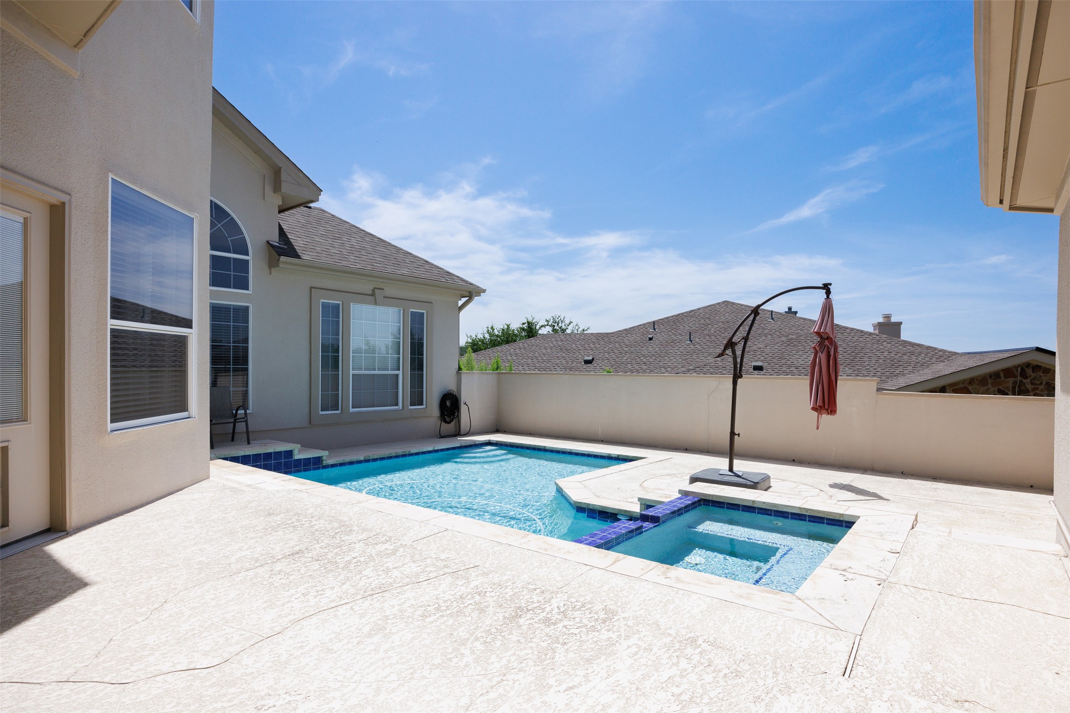 9300 Simmons Road Austin, TX 78759 - Photo 15 of 17 An inviting private pool and spa offer a refreshing oasis behind this charming residence.