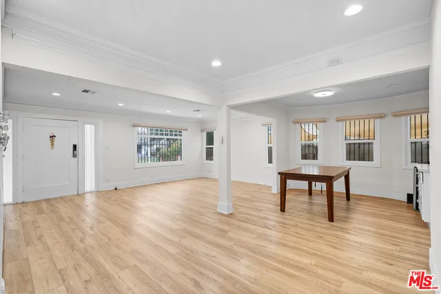 a view of a livingroom with wooden floor and a window