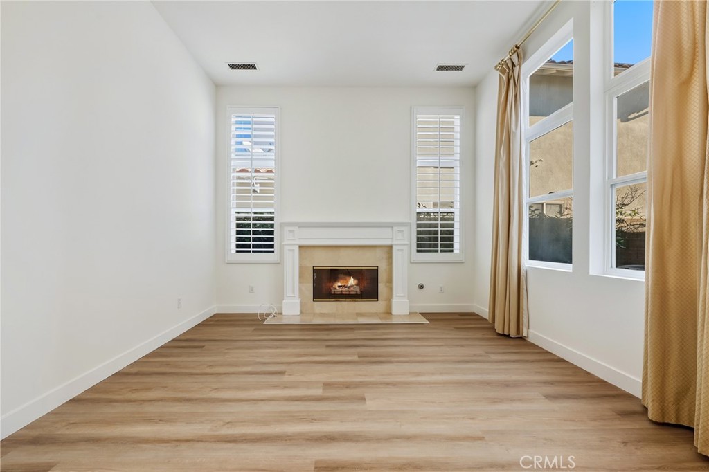 6 Sutton Irvine, CA 92618 - Photo 4 of 32 Formal living room (Fire in the fireplace has been edited)