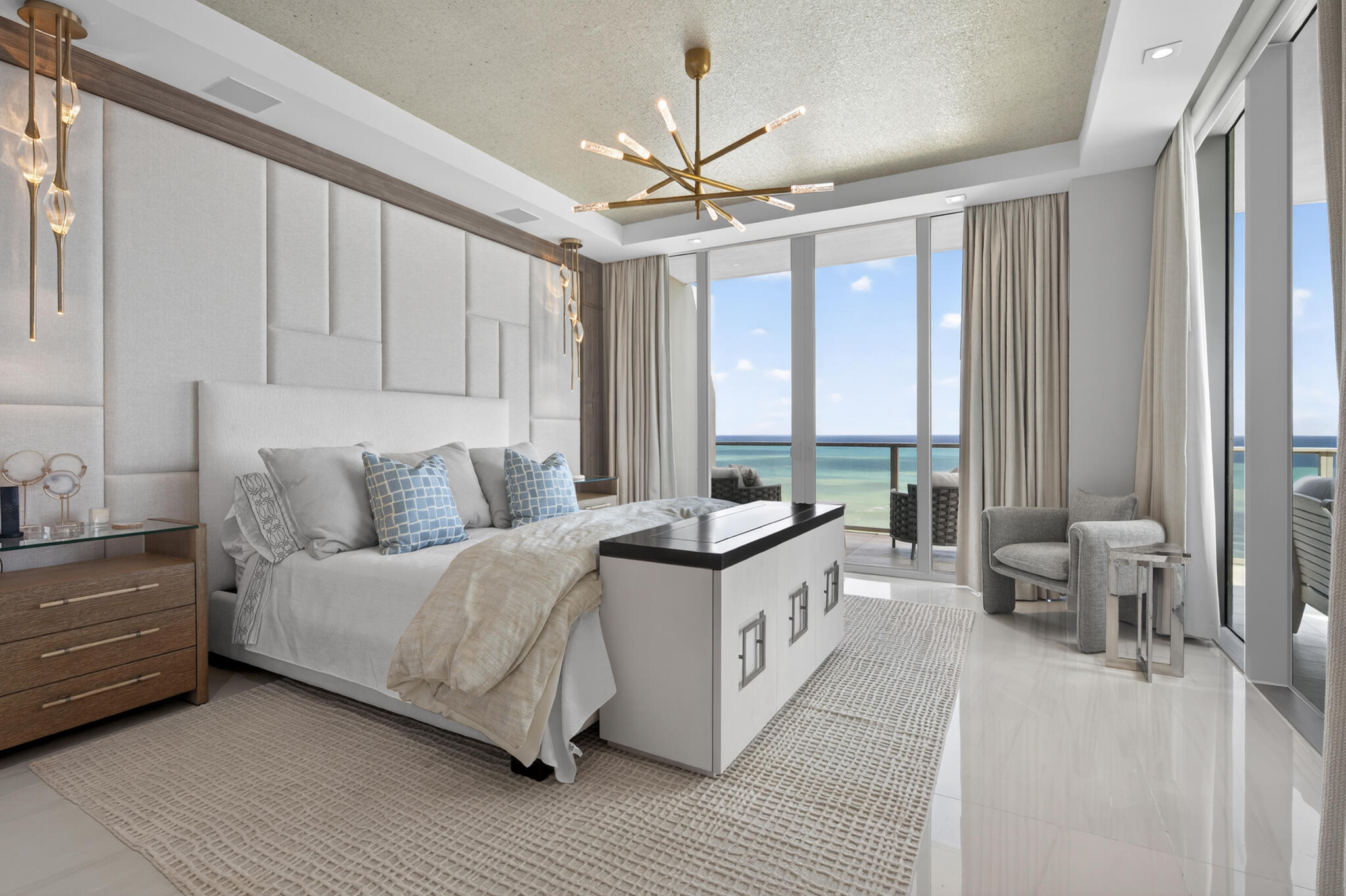 3100 North Ocean Drive, Unit HPH3 Riviera Beach, FL 33404 - Photo 19 of 42 a spacious bedroom with a large bed and a chandelier