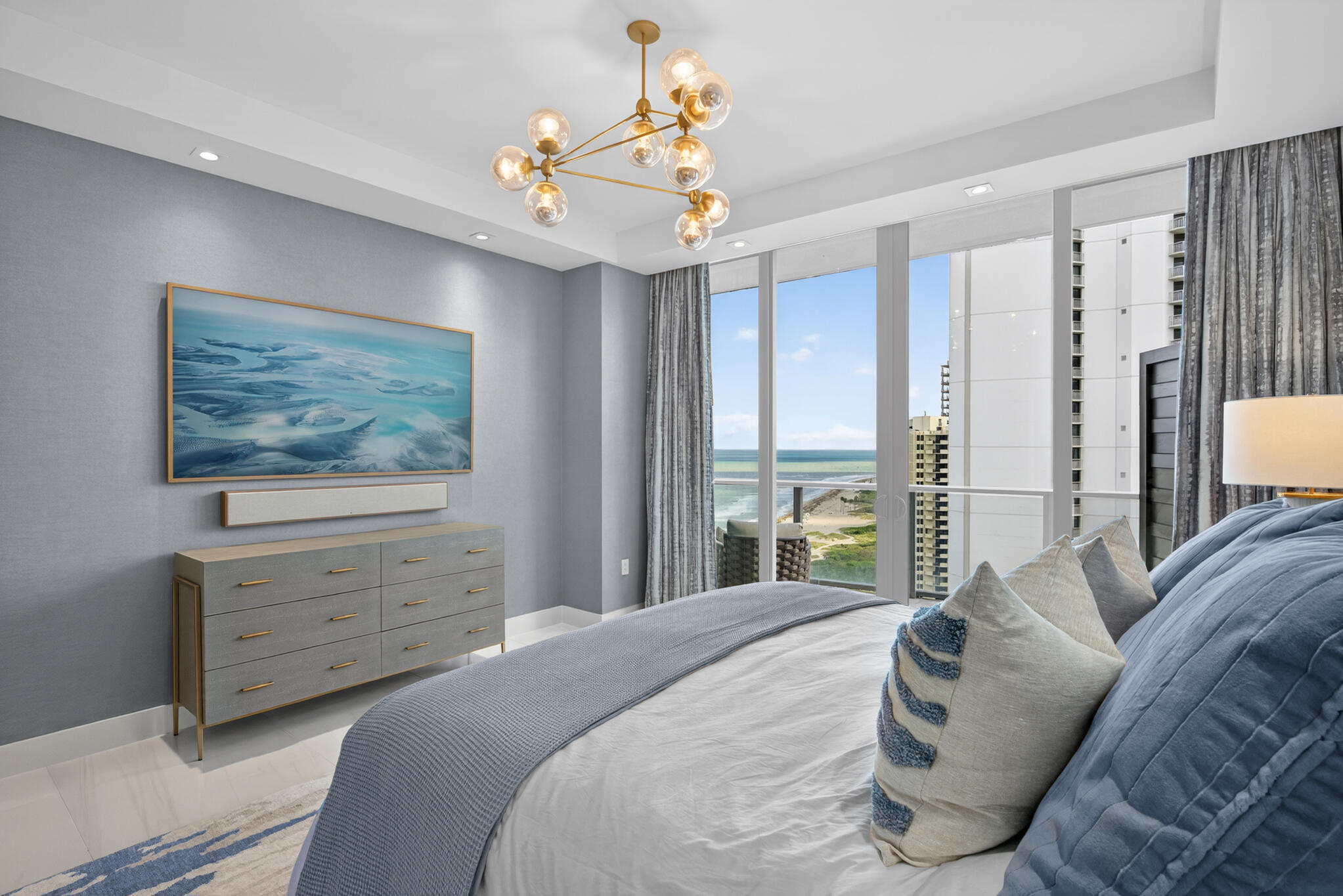3100 North Ocean Drive, Unit HPH3 Riviera Beach, FL 33404 - Photo 29 of 42 a bedroom with a large bed and a chandelier