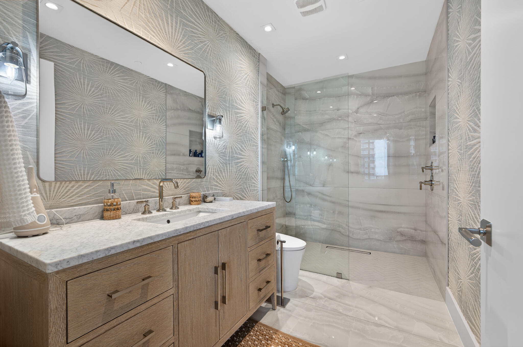 3100 North Ocean Drive, Unit HPH3 Riviera Beach, FL 33404 - Photo 32 of 42 a bathroom with a double vanity sink toilet mirror and bathtub