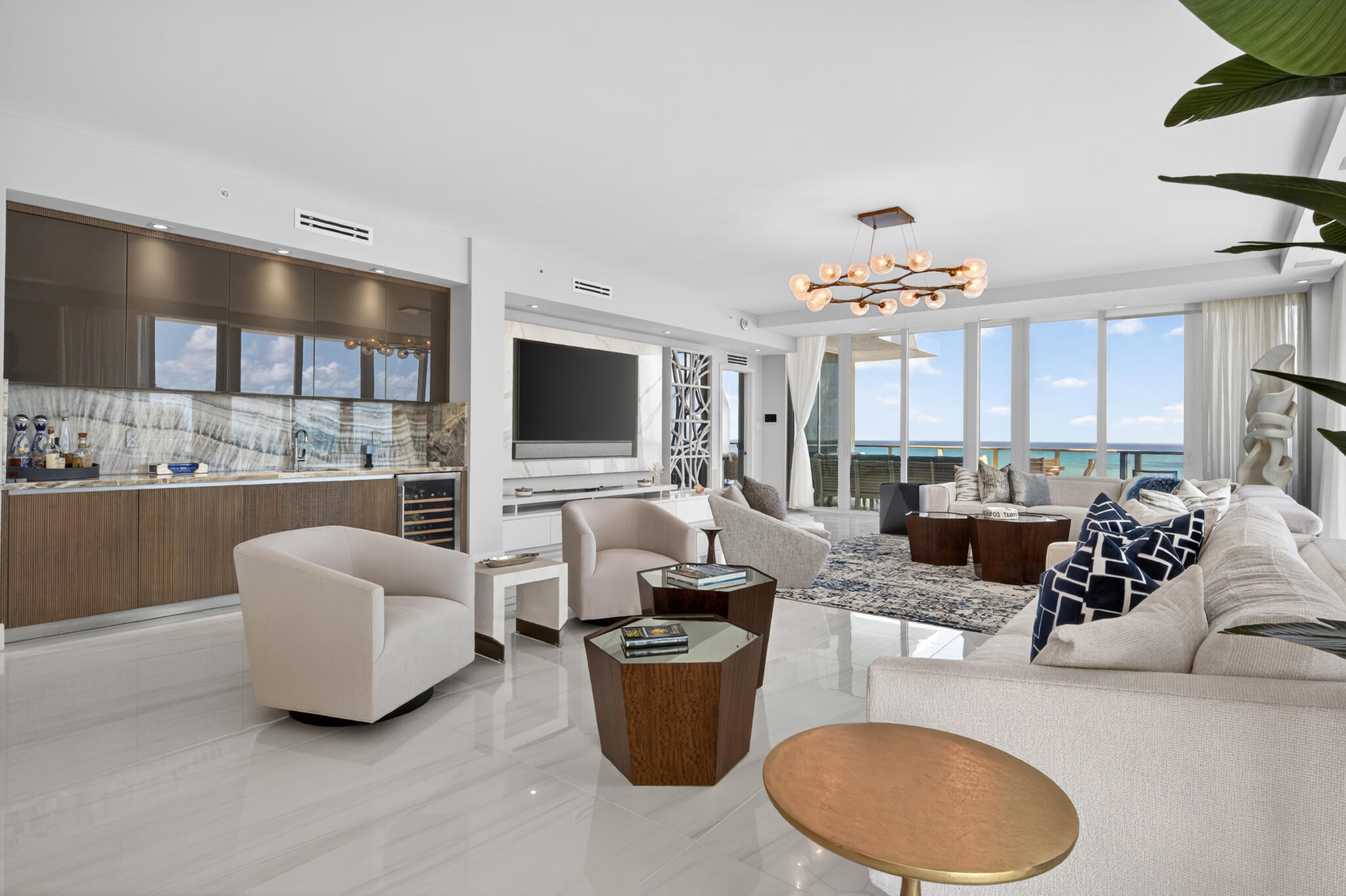 3100 North Ocean Drive, Unit HPH3 Riviera Beach, FL 33404 - Photo 5 of 42 a living room with furniture a chandelier and a flat screen tv