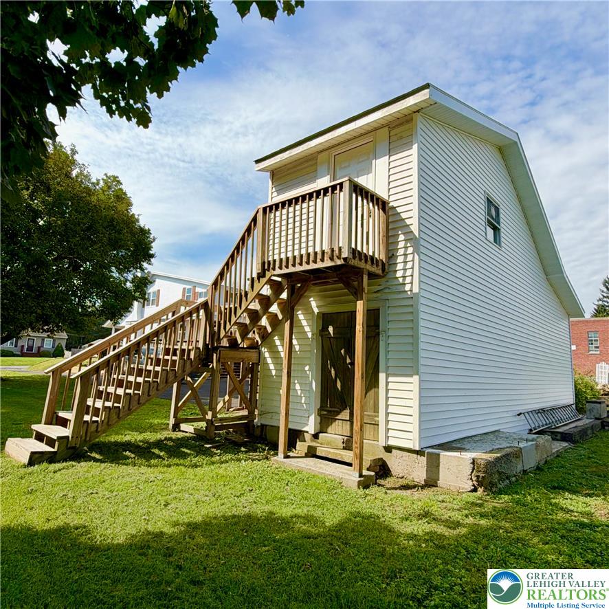 5111 Vera Cruz Road Emmaus, PA 18049 - Photo 41 of 44 A detached two-story outbuilding offers versatile storage and workshop potential on a grassy lawn.