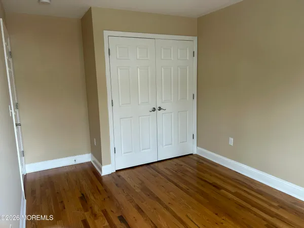 a view of room with hardwood floor