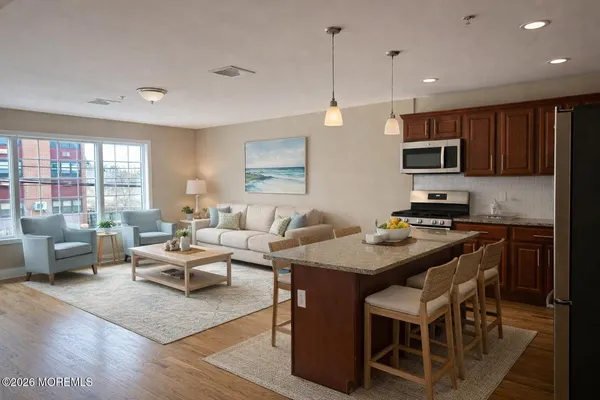 a kitchen with a table chairs a sink dishwasher stove and cabinets with wooden floor