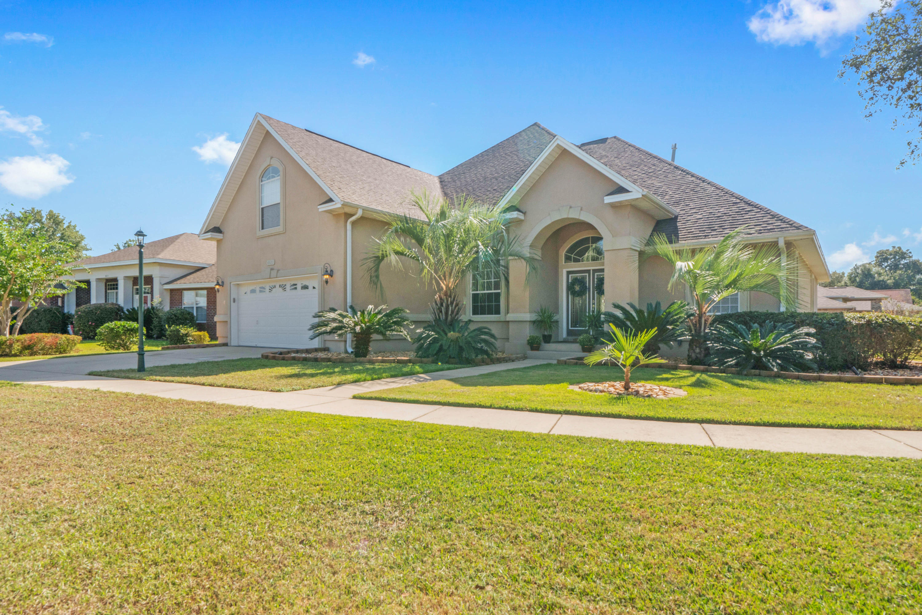 4611 Chanan Drive Crestview, FL 32539 - Photo 1 of 39 a view of a house with a swimming pool and a yard