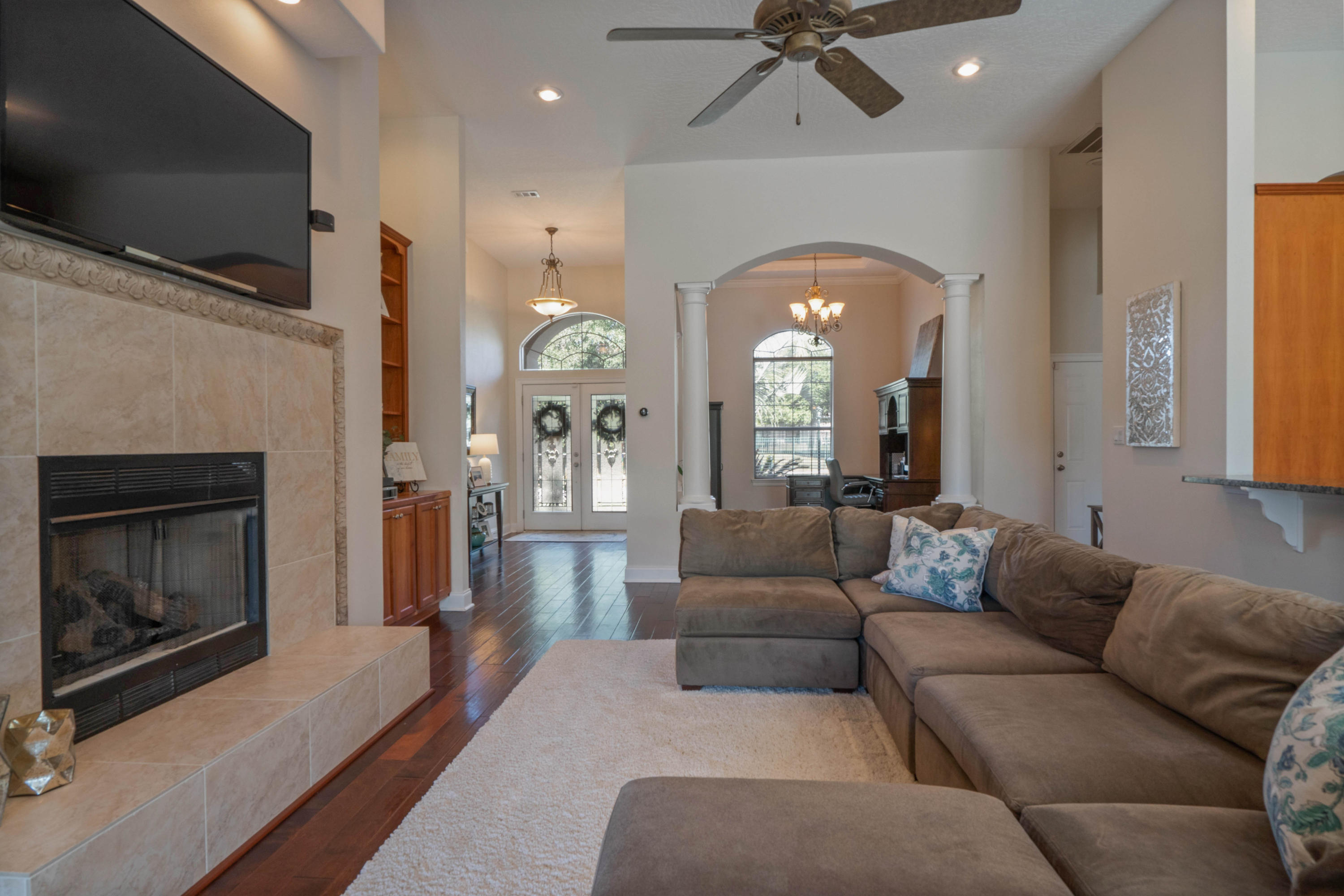 4611 Chanan Drive Crestview, FL 32539 - Photo 14 of 39 a living room with furniture a fireplace and a flat screen tv